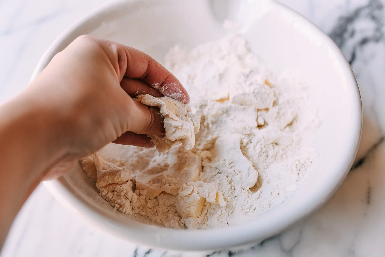 Butter mixed into flour until coarse crumbs form